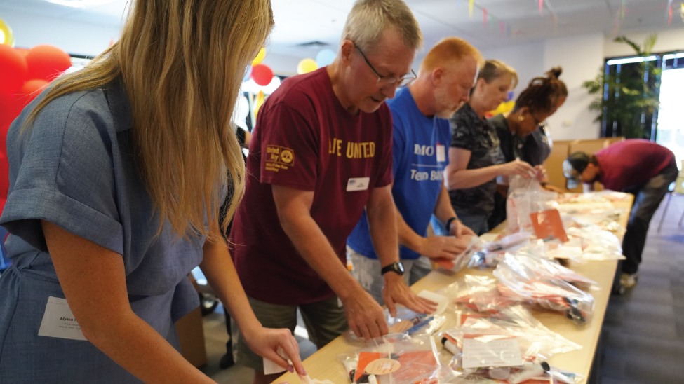 Volunteers build heat relief kits