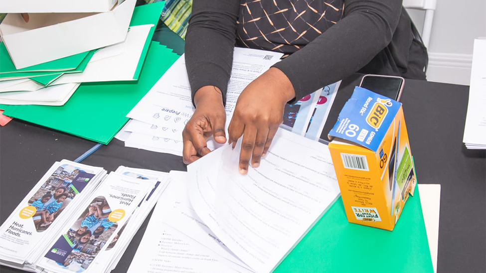 A United We prepare volunteer hands out printed preparedness materials