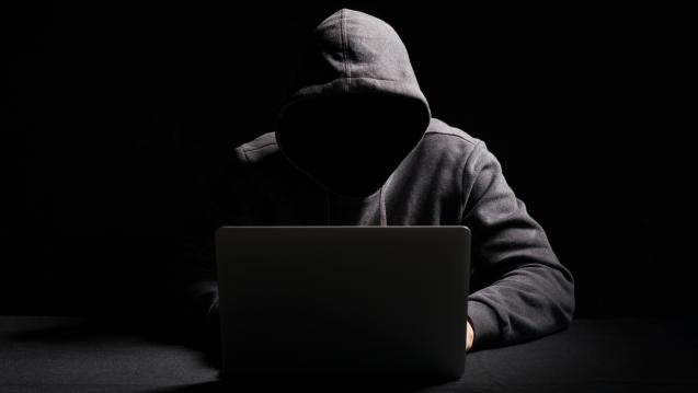 men with hood on computer