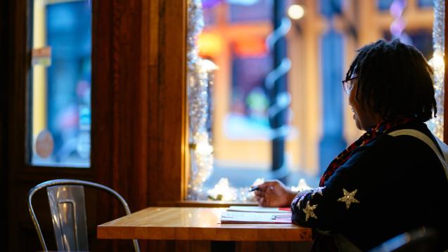Woman sitting in a coffee shop looking out of the window