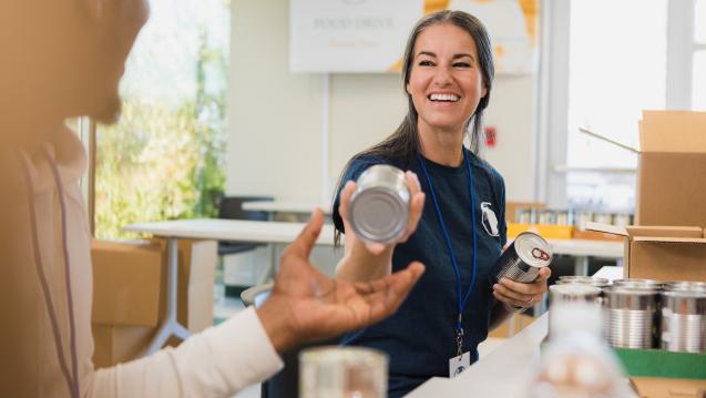 Woman at a food pantry sorting cans