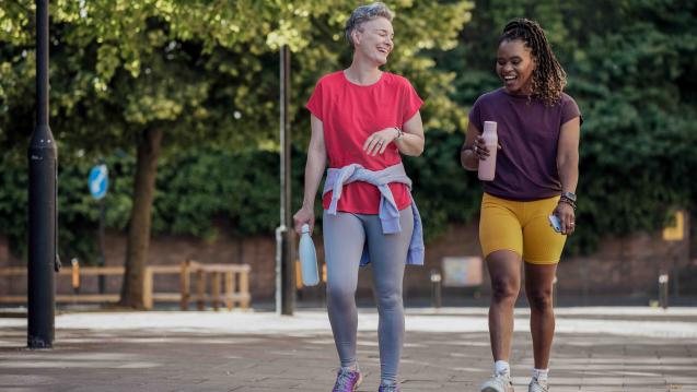 Two women in exercise clothes walking outside together
