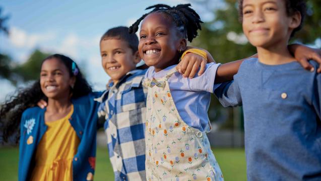 Children standing happily outside together