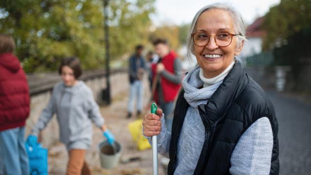 Older woman volunteering outdoors
