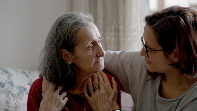 A woman with her arm around an elderly womn