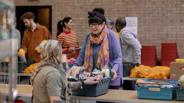 Volunteer supplying food to a person in need.