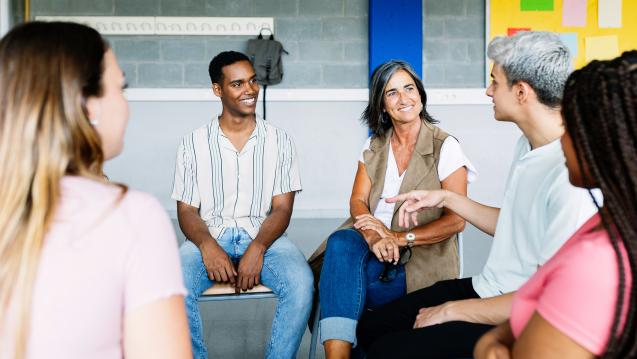 Young adults sitting in a support circle of peers