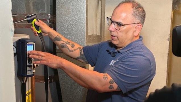 A professional evaluating weatherization of appliances