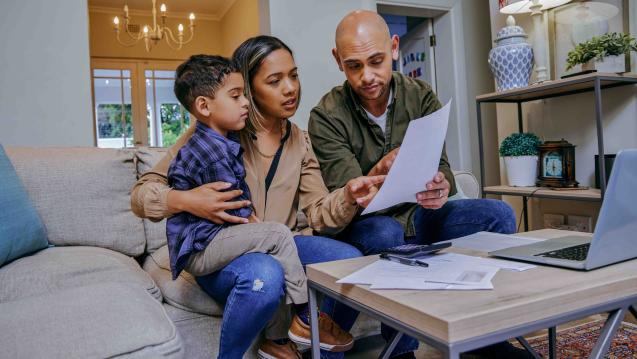 A family looking at their finances in the living room