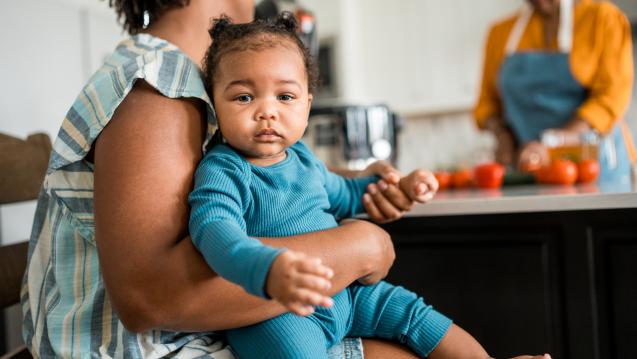 A baby in the lap of an adult