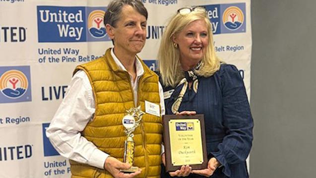 Kim Duckworth receives a volunteer award from Betsy Ivey, Executive Director - United Way of the Pine Belt Region, MS.