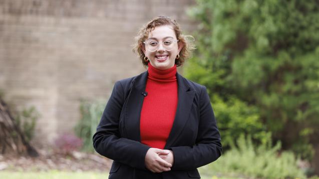 Serafina Acceta standing in a walled garden 
