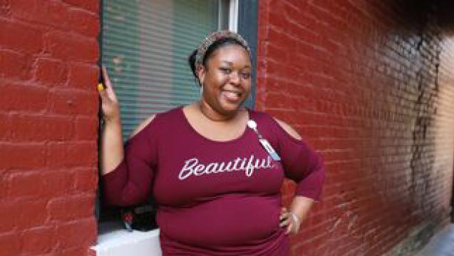 Ariel smiling wearing shirt that says beautiful. 