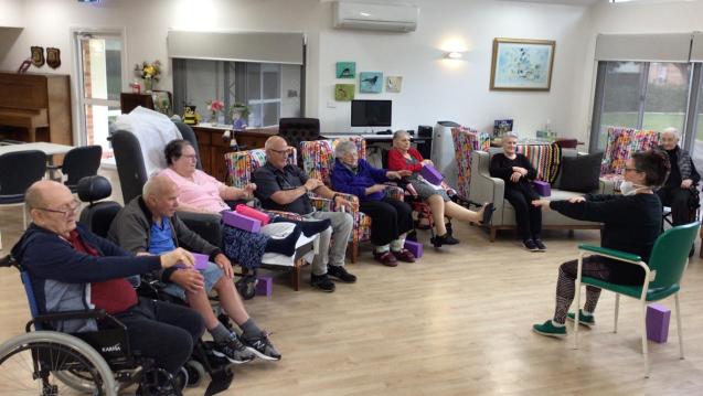 A chair yoga class in Harbourside Lodge, Glenelg, Australia