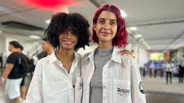 Two young people wearing white coats