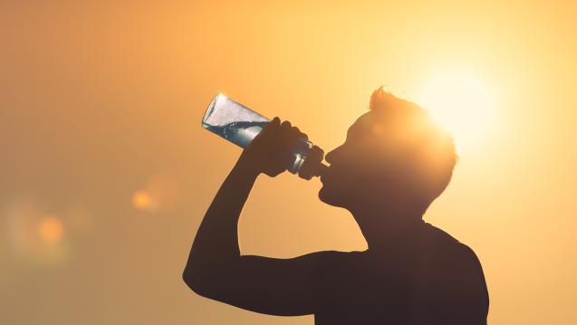 Man drinking water in sun