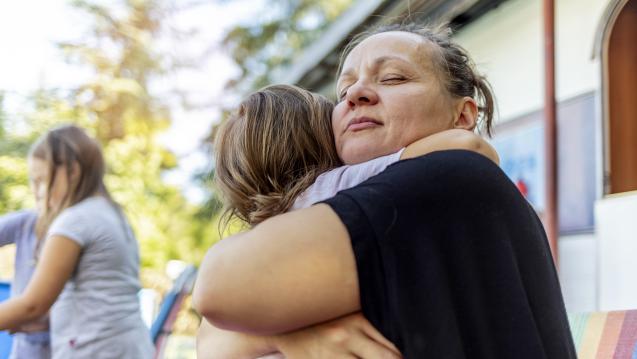 Mom and daughter embracing after tragedy