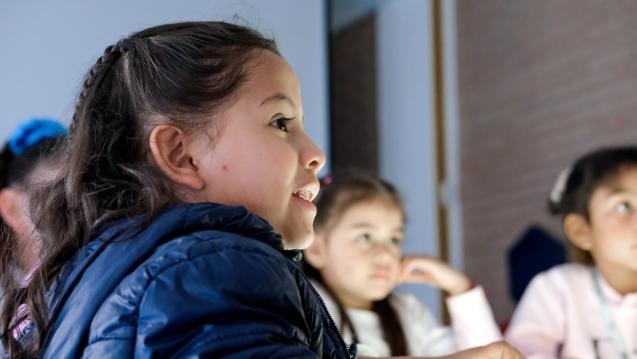 Girls Listening to a Teacher