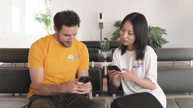 Two people exchanging information while looking at their phones