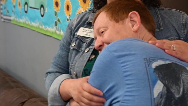Young person hugging Kristin Hegji