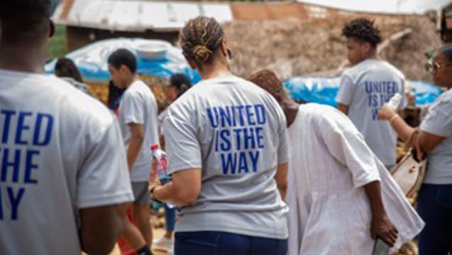 A person wearing a United is the Way T-shirt walking in Accra, Ghana 