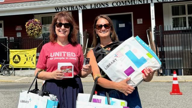 Library workers hold books to take to children evacuees