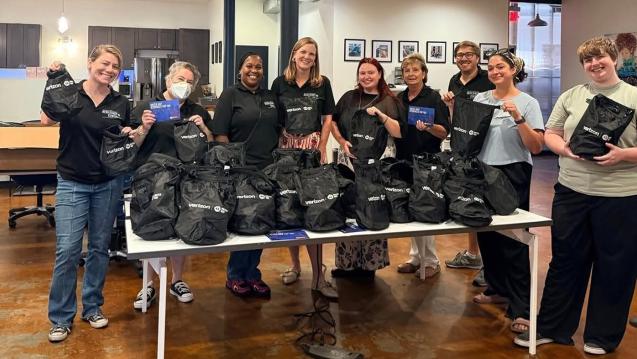 Volunteers at the United Way Resiliency Center in new Orleans hold up emergency kits