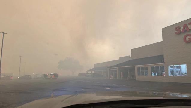 Wildfires burn by a shopping center in Valdosta, Georgia