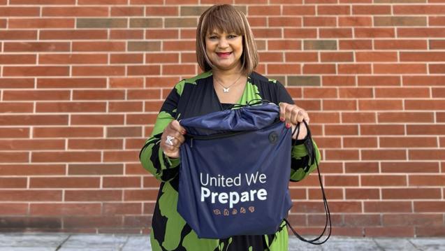 Arnita DeShields holding a United We Prepare emergency kit