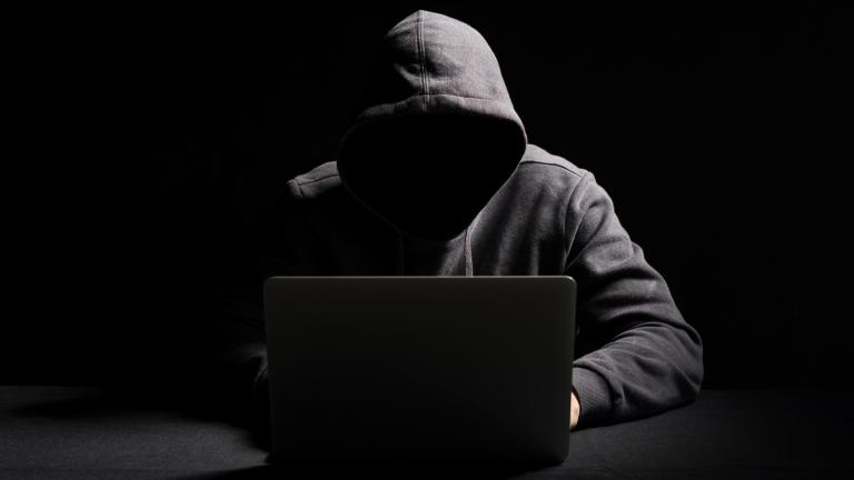 men with hood on computer