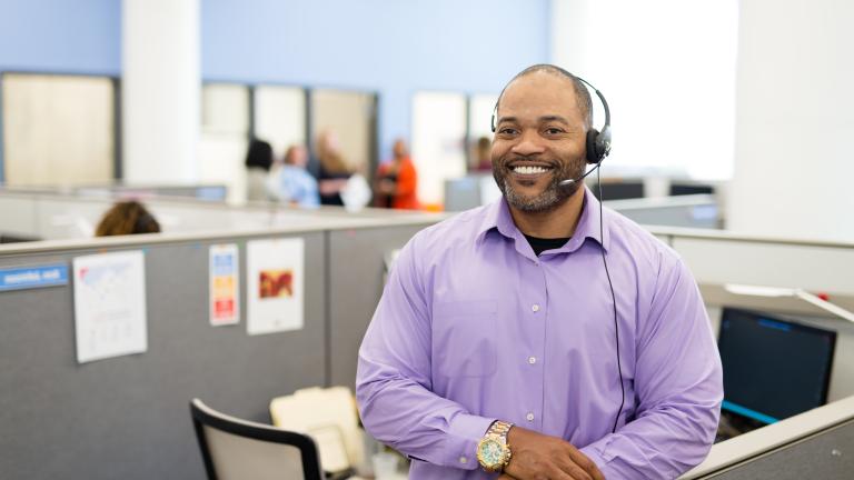 Man in purple shirt with 2-1-1 headset on