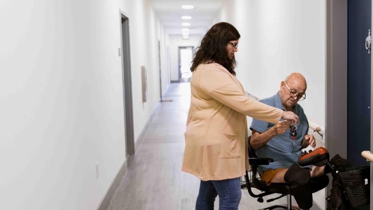 Man in motorized wheelchair arrives at a door