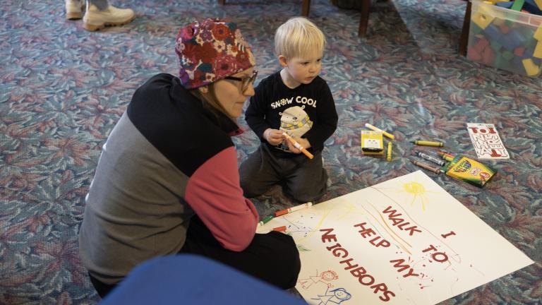 Woman and child creating a poster together
