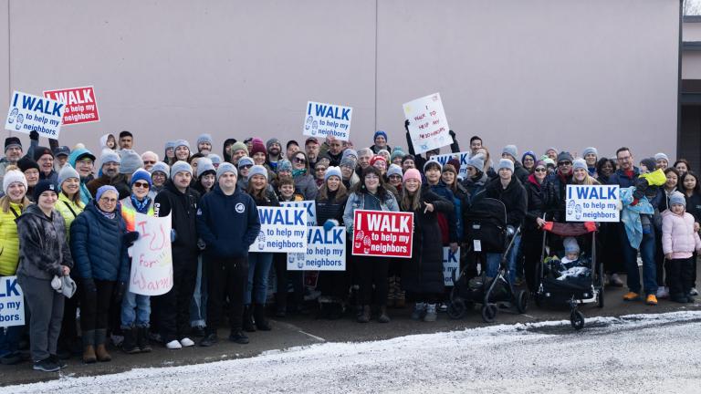 Group of individuals with signs outside
