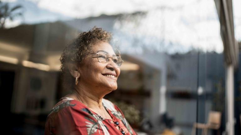 Woman looking out of a large window
