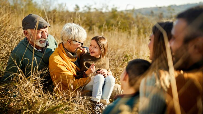 Family sitting in a field of grain