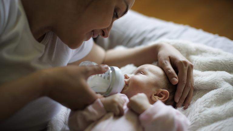 Mother giving a bottle to a newborn baby