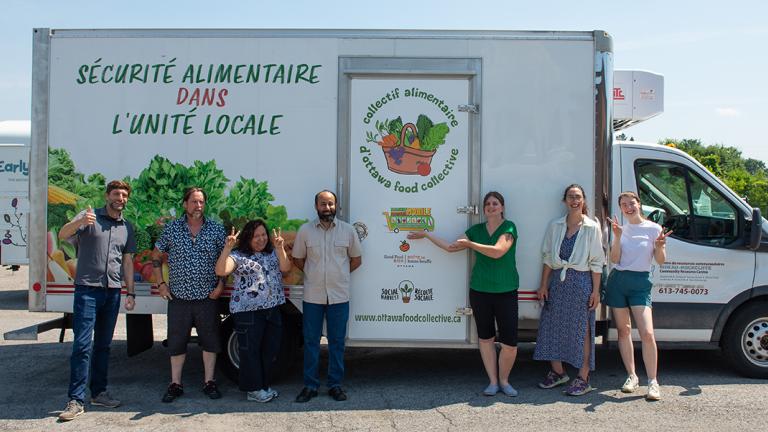 United Way representatives with food storage container