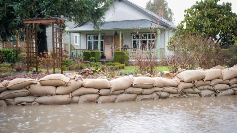 Sandbags in front of a house prevent flooding from impacting the home