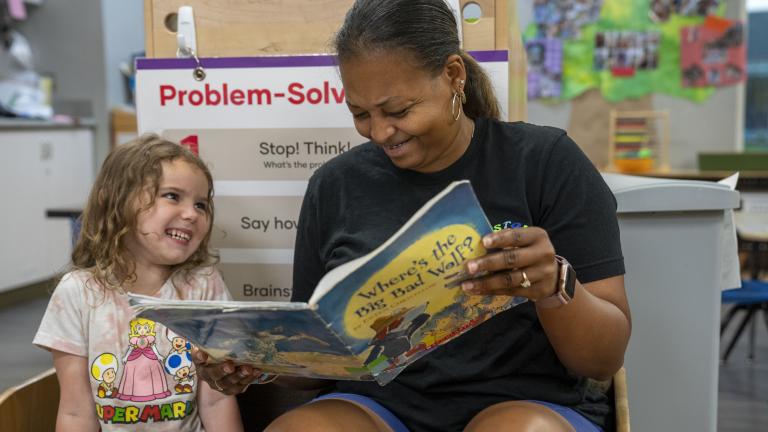 A staff member reading to a student