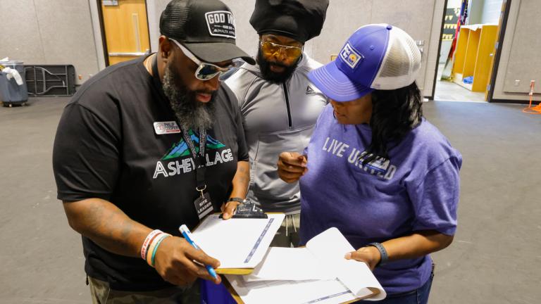 United Way staff meeting with community members to give assistance