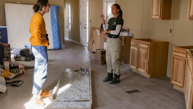 Volunteer working to restore the inside of a damaged home