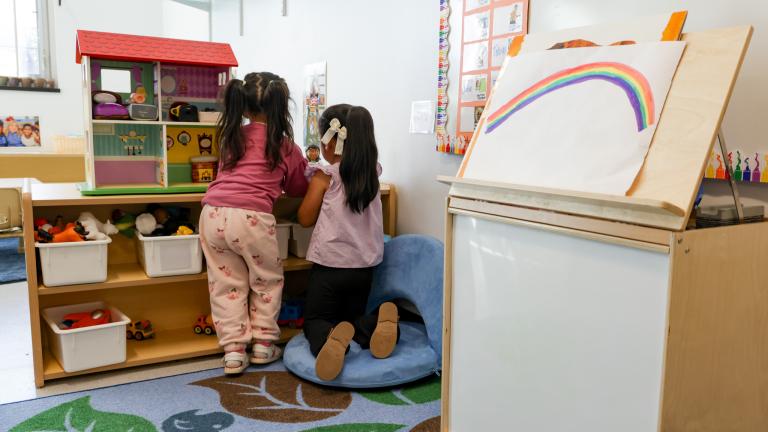 Two children playing in a classroom