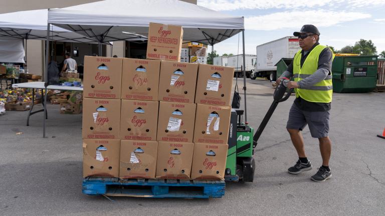 Man pushing a pallet of food at a United Way event