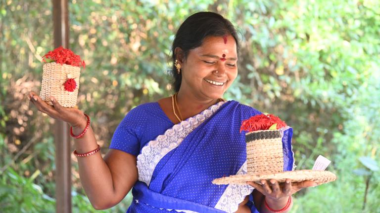 Woman holding crafts that she has created for sale