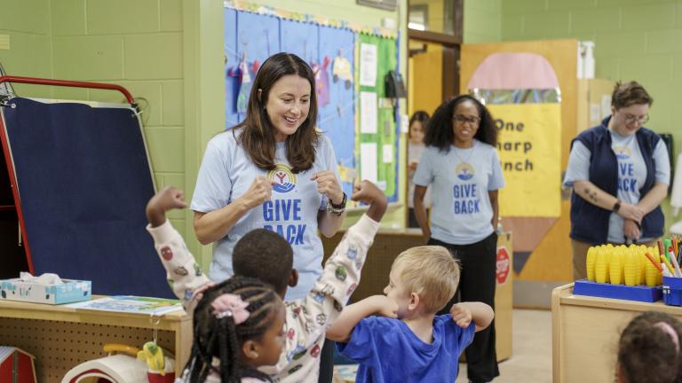 Children in a classroom with United Way adults