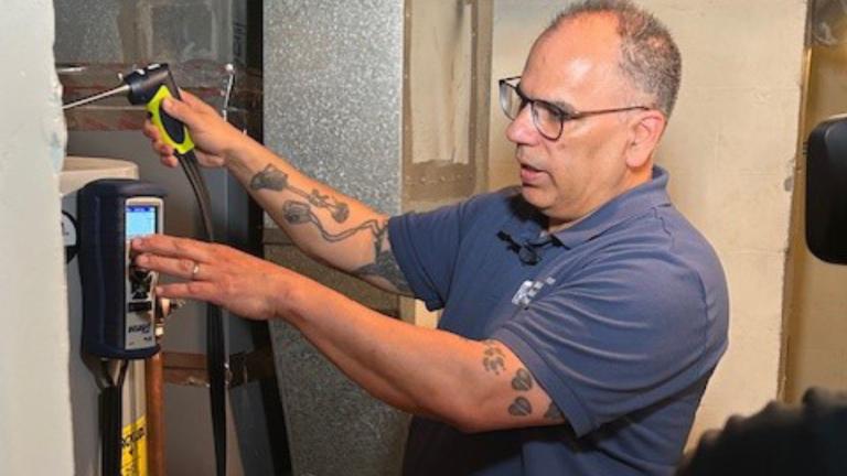 A professional evaluating weatherization of appliances