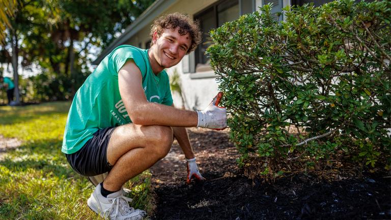 United Way volunteer helps install mulch and plants 