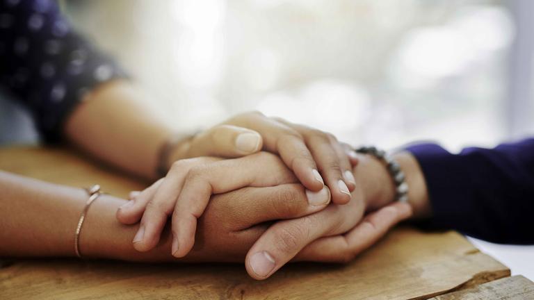 close up of two people holding hands