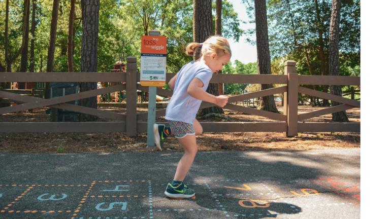 A preschool playing hopscotch on Born Learning Trail 